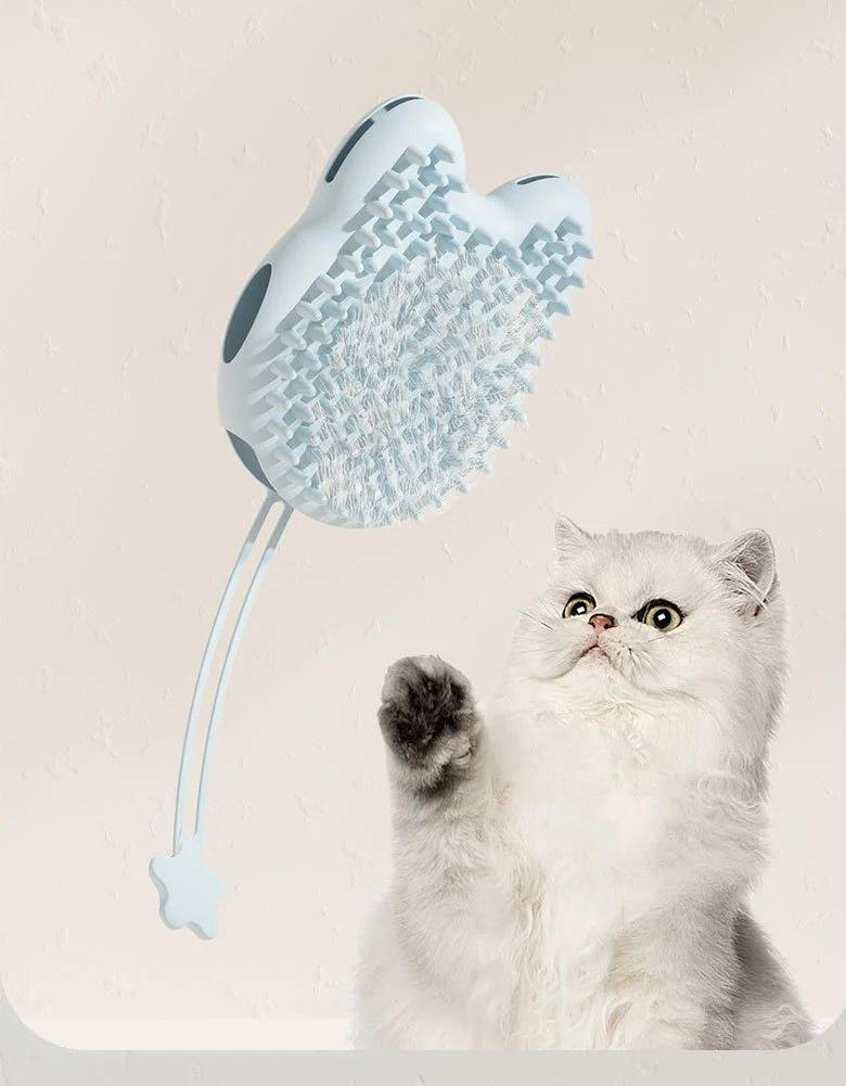 White Persian cat pawing at a blue grooming brush
