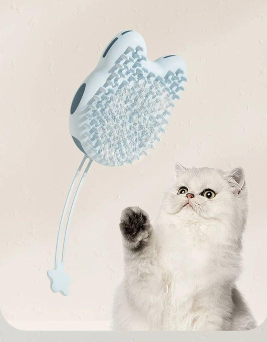 White Persian cat pawing at a blue grooming brush